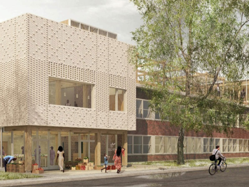 EN: A newly constructed, two-storey modern building with geometric patterns and large windows. FR: Un bâtiment moderne de deux étages récemment construit avec des motifs géométriques et de grandes fenêtres.